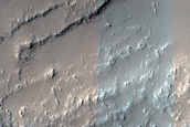 Layers in Crater Wall above Ridged Lava Flow