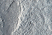 Crater Exposing Layers in Icy Deposits