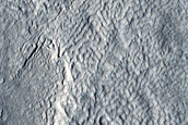 Crater Exposing Layers in Icy Deposits