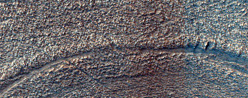 Curved Surface Features in Hellas Planitia