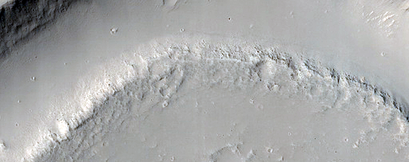 Memnonia Fossae Crater Interrupted by Flow