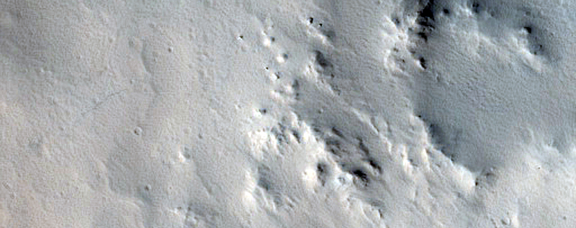 Crater-Related Pitted Materials in 10-Kilometer Crater near Amazonis Planitia 