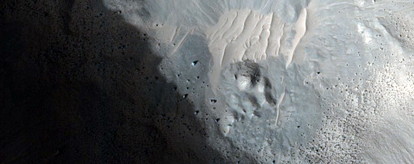 Crater-Related Pitted Materials in 3-Kilometer Crater in Nepenthes Planitia