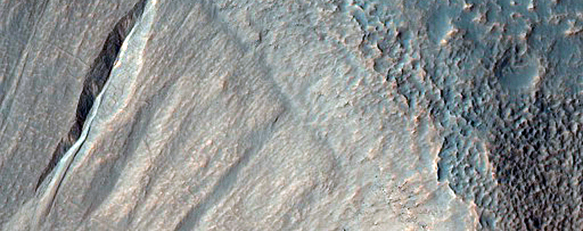 Possible Gully-Associated Light-Toned Materials near Sirenum Fossae