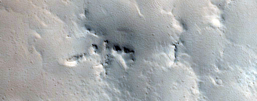 Crater-Related Pitted Materials in 10-Kilometer Crater near Amazonis Planitia 