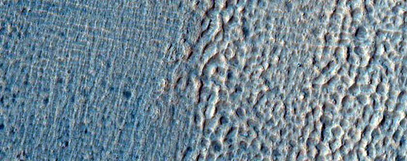 Crater with Ice Deposit Plus Rim Erosion and Gullies
