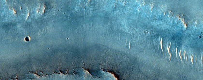 Fluvial Channels in Layered Impact Ejecta