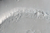Memnonia Fossae Crater Interrupted by Flow