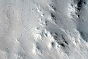 Crater-Related Pitted Materials in 10-Kilometer Crater near Amazonis Planitia 