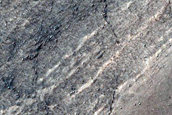 Triangular Scars on Hillslopes