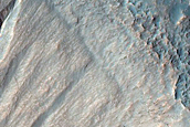 Possible Gully-Associated Light-Toned Materials near Sirenum Fossae