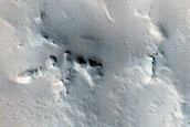 Crater-Related Pitted Materials in 10-Kilometer Crater near Amazonis Planitia 
