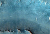 Fluvial Channels in Layered Impact Ejecta